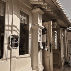 an old fashioned store front with the door open