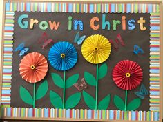 a bulletin board with paper flowers and butterflies on it that says growing christ in the center