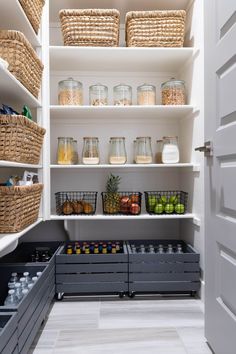 an organized pantry with lots of food in baskets and containers on the shelves, along with empty bins