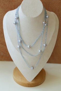 This elegant necklace features a long strand adorned with natural aquamarine and gray pearls, exuding a sophisticated charm. Perfect for adding a touch of refinement to any ensemble, it combines the serene hues of aquamarine with the timeless allure of gray pearls, creating a versatile accessory suitable for both casual and formal occasions. Metal: Recycled Sterling Silver Plated On Brass Gemstone: Aquamarine Pearl: Freshwater Pearls 9-10mm Chain Length: 1400-1450mm Weigth: 29g Elegant Light Blue Single Strand Beaded Necklace, Elegant Gray Gemstone Beads Necklace, Elegant Gray Faceted Beads Necklace, Elegant Gray Necklace With Faceted Beads, Sliver Earrings, Gemstone Beaded Necklace, Long Beaded Necklace, Elegant Necklace, Tiger Eye Stone