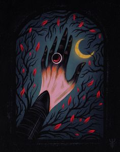 a person's hand reaching for a red ring in the middle of a forest