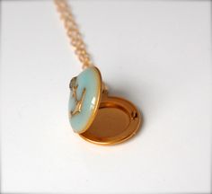 "*IMPORTANT SHIPPING INFORMATION: Verabel will be out of the studio during the month of June 2021. We will still be accepting orders during this time, but please note they will not ship until after July 1, 2021. xo A delicate locket features a brass anchor against a light turquoise enamel. The locket opens to hold two tiny keepsake photographs. Send your pictures through the Etsy conversation feature after purchase and we'll place them for you. ~Locket measures 1/2\" ~18\" brass chain" Tiny Locket, Locket Jewelry, Necklace Locket, Anchor Necklace, Layering Necklaces, Jewelry Lockets, Nautical Wedding, Light Turquoise, July 1