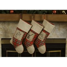 two christmas stockings hanging from a mantel