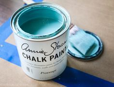 a blue paint can sitting on top of a table