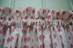 a close up of a pink flowered dress with red flowers