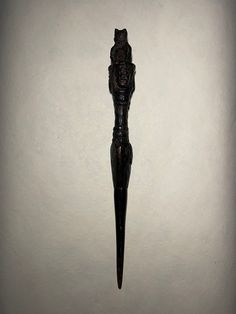 an ornate wooden object is hanging on the wall