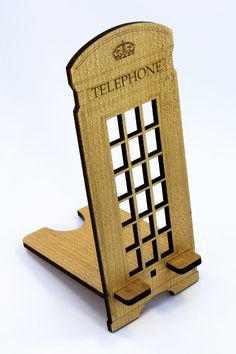 a wooden phone stand with the word telephone printed on it's front and sides