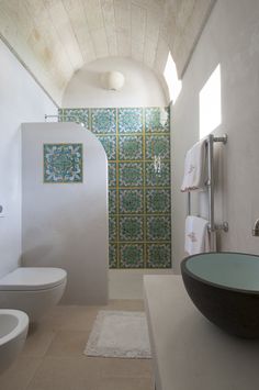 a bathroom with a sink, toilet and shower