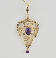 Description  Antique Victorian 9ct gold amethyst lavalier pendant, c1880. 9ct Gold open work lavalier pendant with oval cut milgrain set amethyst to the center & adorned with seed pearls in a foliate design, to the bottom of the pendant a round cut claw set amethyst hangs on it's own loop. To the top, the pendant has a decorative chain loop claw set with two seed pearls. Stamped 9ct to verso. With gift box. A fantastic addition to any collection. Ultrasonically cleaned. Chain not included. Please study the photographs carefully as they form part of the overall description.   Date c1880 Weight 2.43 grams    Dimensions of pendant 52mm x 23mm Condition. Excellent condition. Antique Engraved Purple Jewelry, Victorian Gemstone Oval Pendant Necklace, Victorian Oval Pendant Necklace With Gemstone, Victorian Gemstone Necklace With Oval Pendant, Victorian Oval Pendant Gemstone Necklace, Antique Purple Pendant Necklace, Victorian Gemstone Pendant Jewelry, Victorian Pendant Gemstone Jewelry, Antique Amethyst Pendant Jewelry