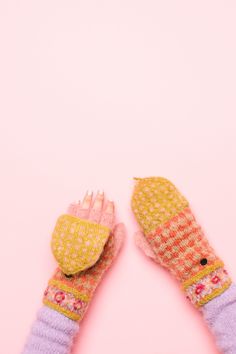 two knitted mittens on top of each other with their fingers in the middle