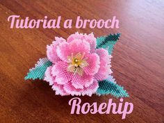 a close up of a flower on a table with the words how to make a brooch