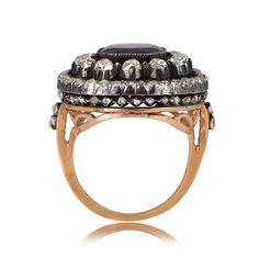 an antique style ring with black and white stones