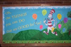 a bulletin board with the dr seuss thing on it and balloons in the air