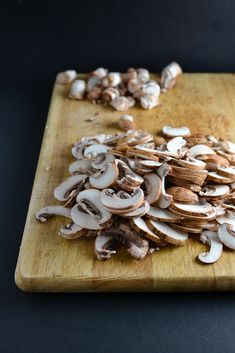 sliced mushrooms on a cutting board next to a knife