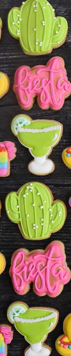 decorated cookies in the shape of cactuses and cacti are displayed on a table