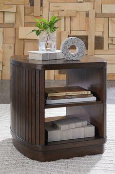 a table with books and a vase on it