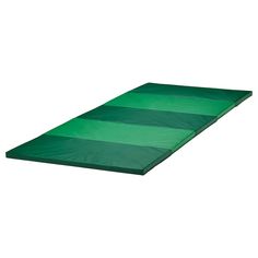 a large green mat on top of a white wall