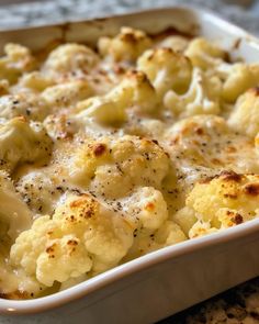 a casserole dish with cauliflower and cheese