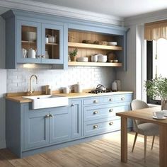 a kitchen with blue cabinets and wooden flooring in the center, along with a dining room table