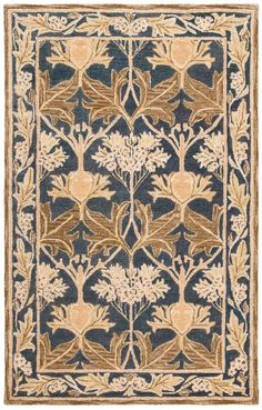 a blue and beige rug with flowers on it