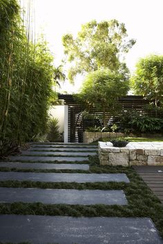 an outdoor garden with stone steps and grass