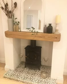 an image of a wood burning stove in the middle of a room with candles on it