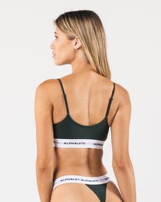 HIGHLIGHTS. Stretchy cotton material. Low impact. Rounded camisole neckline. Easily adjustable straps. Reinforced binding arm and neckline finishing. Custom jacquard waistband with knitted in Alphalete wordmark. Double layered bra construction FIT SUGGESTION. This item runs true to Alphalete’s standard fit.. If you are between sizes, we recommend sizing up for a relaxed fit.. Model is 5’8”/1172cm, wearing a size XS with a 31”/78.7cm bust. MATERIALS AND WASHING DIRECTIONS. 46.5% Cotton, 46.5% Mod V-neck Crop Top With Built-in Bra Athleisure, Sporty Bra-friendly Camisole, Sporty Stretch Camisole With Built-in Bra, Sporty Camisole Sports Bra With Built-in Bra, Bra Construction, Solid Camisole Sports Bra, Fitted, Neckline Finishing, Bralette, Cotton Material