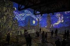 people are standing in front of the starry night painting at an art museum,