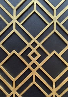 a black and gold wallpaper with an intricate design on the top half of it