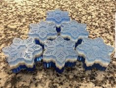 four snowflakes sitting on top of a granite counter