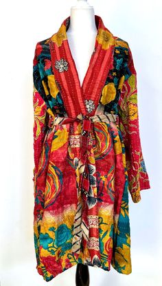 Kantha Kimono Coat Will Exceed Your Expectations. Each coat is engineered with fashion in mind. Tailored as a trench coat, intended to be worn as an outerwear piece. Stunning example of kantha stitching, mixed print, exhibiting refined craftsmanship. Soft, Colorful, and Easy. One of a kind. Designer details throughout. This statement piece is crafted from ultra lux kantha stitch vintage cotton sari. Features long sleeves, two deep interior pockets with a wide self tie matching belt. Absolutely a Spring Outerwear With Patchwork And Kimono Sleeves, Red Long Patchwork Outerwear, Long Red Patchwork Outerwear, Winter Outerwear With Patchwork And Kimono Sleeves, Fall Patchwork Long Kimono, Fitted Outerwear With Kimono Sleeves For Fall, Spring Long Coat Outerwear With Patchwork, Spring Long Coat With Patchwork, Red Long Sleeve Kimono For Spring