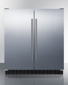 a stainless steel double door freezer sitting on top of a counter