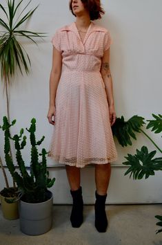 "Fifties Pink Party Dress. Textured Overlay. Wing Collar. Midriff Yoke Waistline. Metal Zipper Closure Up Side. Shoulder Pads. Lined. No Content Label, Feels Synthetic Good Vintage Condition - General Wear. Discolouration and Stains Around Hem. Seam Rip Above Zipper. Faint Armpit Stains. Some Rips In Overlay. Fits Size Small Chest - 36\" Waist - 28\" Hip - 40\" Shoulder to Hem - 42.5\" All Sales Are Final. We have taken the time to note all size measurements and the condition of each piece so pl Vintage V-neck Party Dress, Vintage V-neck Dresses For Vintage Events, Vintage V-neck Dress For Vintage Events, Vintage Fit And Flare V-neck Dress, Vintage V-neck Fit And Flare Dress, Vintage V-neck Cocktail Dress, Fitted 1950s V-neck Dress, Lined Vintage Dress For Spring Party, Knee-length Lined Vintage Party Dress