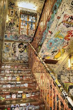 the stairs are covered with graffiti and stickers