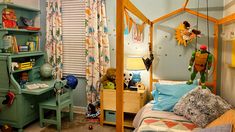 a child's bedroom decorated in blue and yellow