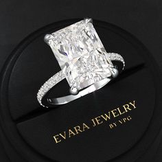 a diamond ring sitting on top of a black box with the name evara jewelry