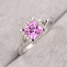 ◆ The ring is handcrafted from sterling silver and decorated with a dazzling 6*6 mm pink sapphire and CZs. It is suitable for engagement/anniversary/daily occasion. ◆ Production Description: Main stone Type: Lab Pink Sapphire Main Stone Shape: Princess Cut Main Stone Size: 6*6 mm(1.37ct) Side stone: CZ Metal: 925 Sterling silver - Other options available in the drop down menu ◆ Customization: √Free for Add Engraving √Other Metal Type Available √Other Gemstones & Shapes Available √Personalization Fine Jewelry Pink Halo Ring With Accent Stones, Pink Diamond Ring With Halo Setting For Formal Occasions, Pink Diamond Ring With Halo Setting For Formal Events, Dazzling Pink Sapphire Rings With Brilliant Cut, Pink Halo Ring With Prong Setting For Formal Occasions, Formal Pink Sapphire Diamond Ring With Halo Setting, Formal Pink Halo Ring With Prong Setting, Pink Sapphire Ring With Halo Setting For Formal Occasions, Pink Halo Ring With Accent Stones For Formal Occasions