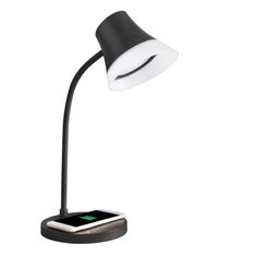 a black and white lamp with a cell phone on it