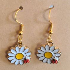 Cute Dangle Earrings Featuring A White Daisy With The Typical Yellow Center Being Visited By A Red Ladybug. Gold Tone Hooks. Measures Just Over 1.5 Inches From The Top Of The Hook To The Bottom Of The Flower. These Would Make A Great Stocking Stuffer Or Birthday Gift! New From Non-Smoking, Pet-Free Home. Fun White Flower-shaped Jewelry, Casual Yellow Earrings Perfect For Gifts, Casual Yellow Earrings For Gift, Summer Yellow Metal Jewelry, Cute Yellow Earrings For Spring, Cute Gold Flower Earrings For Spring, Cute Gold Earrings For Spring, Casual Yellow Drop Earrings, Casual Gold Flower Shaped Jewelry