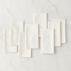 six white napkins laid out on top of each other