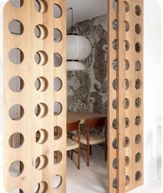 a room divider made out of wood with holes in it