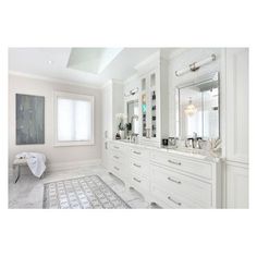 a large bathroom with two sinks and mirrors