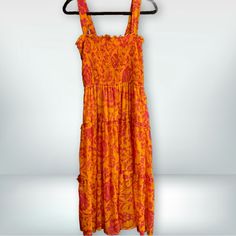 Umgee Size L 100% Polyester Nwt Step Into Summer With This Striking Umgee Dress, Boasting A Vivid Orange And Pink Floral Print That’s Sure To Turn Heads. This Dress Features An Elastic, Smocked Bodice For A Snug And Flattering Fit, Coupled With Adjustable Straps To Ensure Perfect Comfort. The Tiered Skirt Adds A Playful Touch, Making It Ideal For Both Day Events And Casual Evenings Out. A Must-Have For Your Seasonal Wardrobe, This Dress Combines Both Style And Ease. Multicolor Ruched Midi Dress For Vacation, Pink Summer Dress With Elastic Neckline, Pink Vacation Dress With Elastic Neckline, Pink Dress With Elastic Neckline For Vacation, Vacation Smocked Sundress Maxi Dress, Vacation Smock Sundress Maxi Dress, Yellow Beach Midi Dress With Smocked Back, Yellow Midi Dress For Beach With Smocked Back, Yellow Smocked Summer Dress For Beach