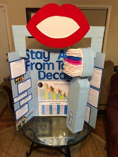 a display with toothbrushes and paper bags on it's head that says stay from the decay