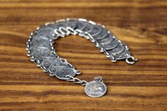 "Original and authentic mid-20th-century coin bracelet from Venice Italy. Engraved on one side of the coin is the symbol of Venice - the \"Winged Lion\" and on the other side, of course, motifs of a gondolier and the amazing canals in the City. Fine and small the bracelet is an amazing and unique gift. A very rare find. Very good condition. Only For Connoisseurs! Dimensions:  LENGTH -20cm/ 8\" WIDTH - 2cm/0.8\" WEIGHT - 0.025kg/ 1 oz" Vintage Handmade Round Chain Bracelet, Handmade Vintage Round Chain Bracelet, Vintage Stamped Round Bracelets, Vintage Medallion Bracelet For Gift, Vintage Hallmarked Round Chain Bracelet, Antique Nickel-free Bracelets, Vintage Stamped Coin Jewelry, Vintage Silver Coin Bracelets, Silver Coin-shaped Engraved Bracelets