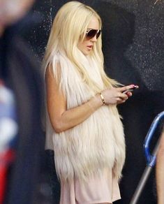 lady with long blonde hair using her cell phone