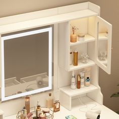 a bathroom vanity with an illuminated mirror and shelves on the wall above it, along with various personal care items