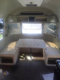 the inside of a camper that is being used as a dining table and bench