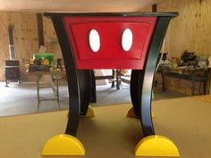 a mickey mouse table in the shape of a chair with two eyes on it's legs