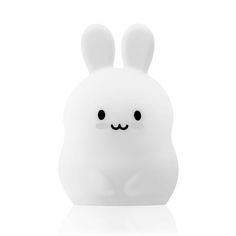 a small white toy with black eyes and ears